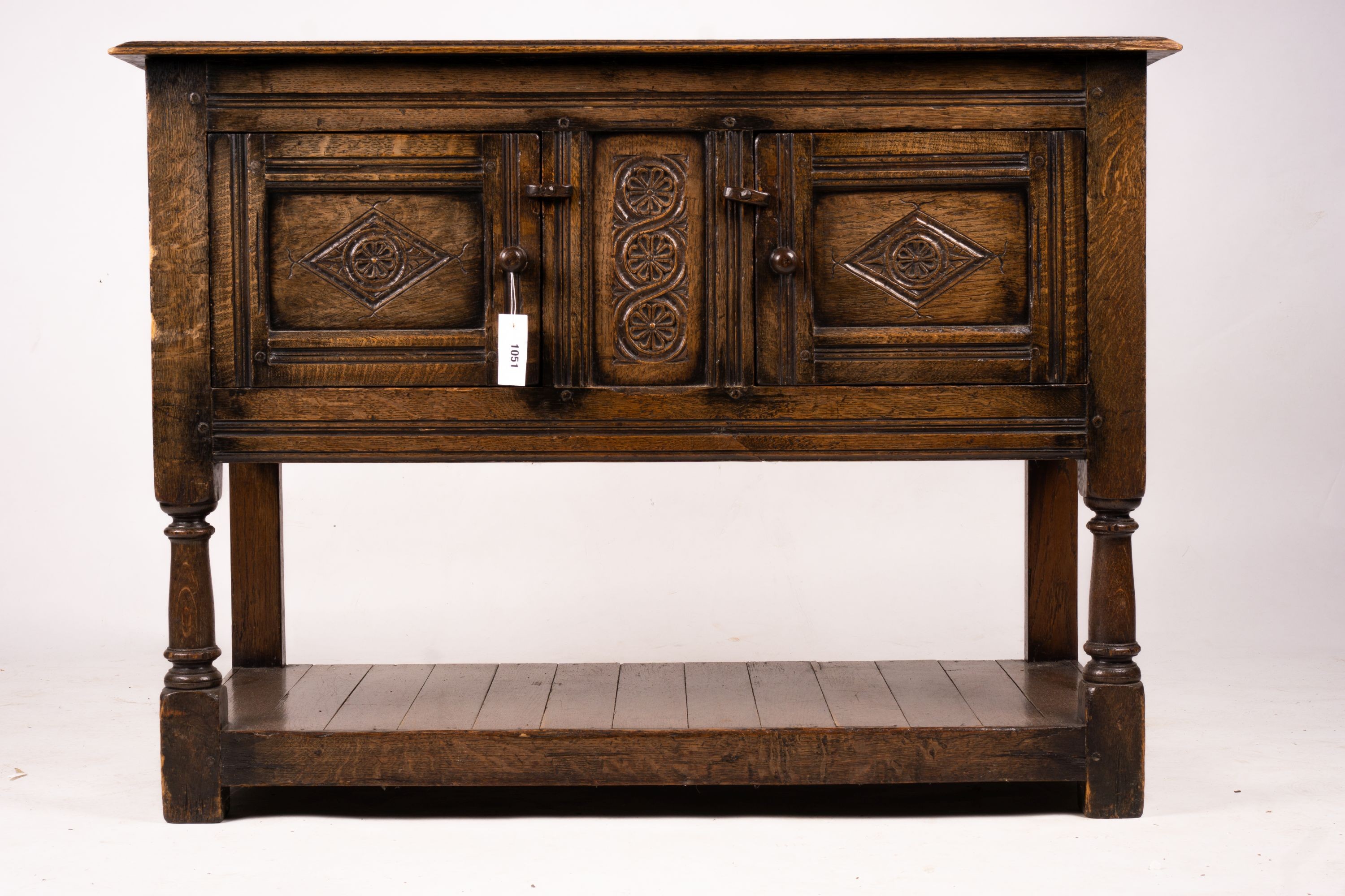 An 18th century style oak two door low cupboard, width 106cm, depth 50cm, height 78cm